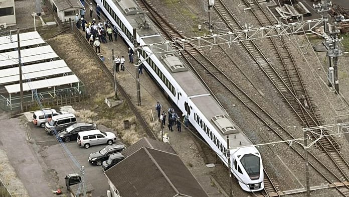 Tokyo-bound express train hits and kills four workers at railway station in Japan